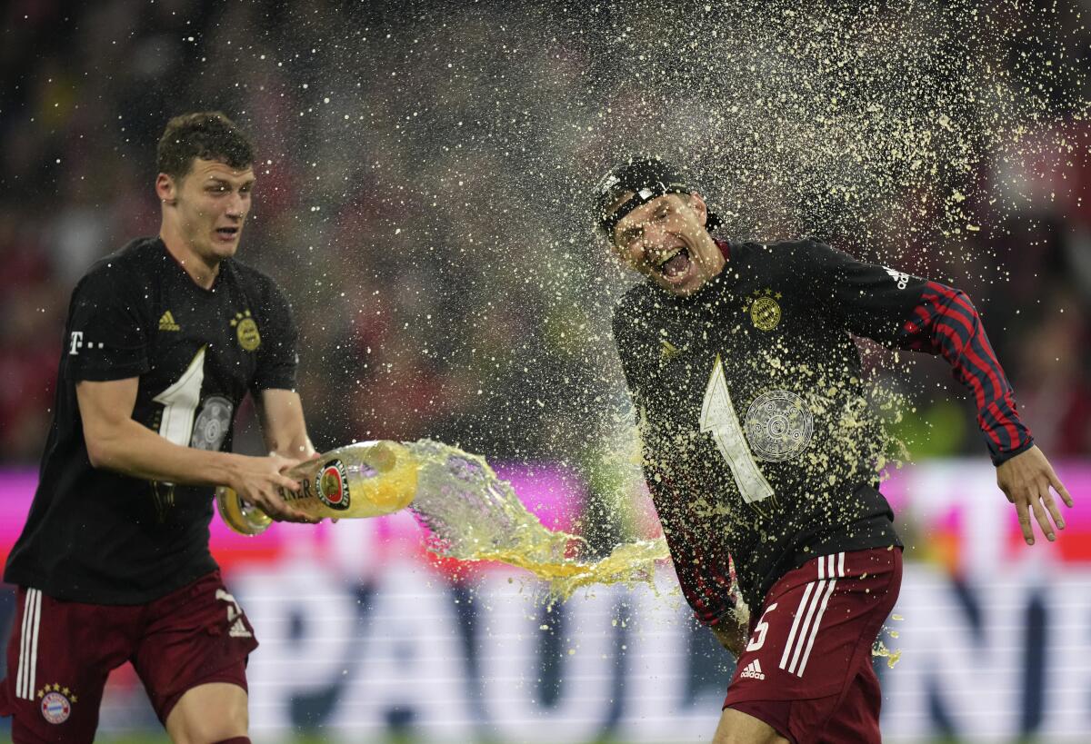 Bayern's Benjamin Pavard, left, and Thomas Mueller celebrate after winning Saturday.