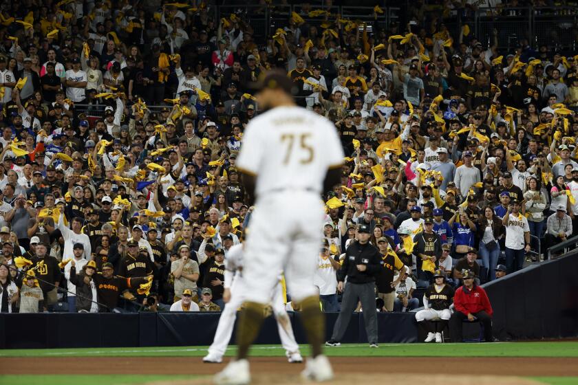 San Diego, CA - October 14: Fans cheer as San Diego Padres relief pitcher Robert Suarez prepares to pitch during the eighth inning in game 3 of the NLDS against the Los Angeles Dodgers at Petco Park on Friday, Oct. 14, 2022 in San Diego, CA. (K.C. Alfred / The San Diego Union-Tribune)