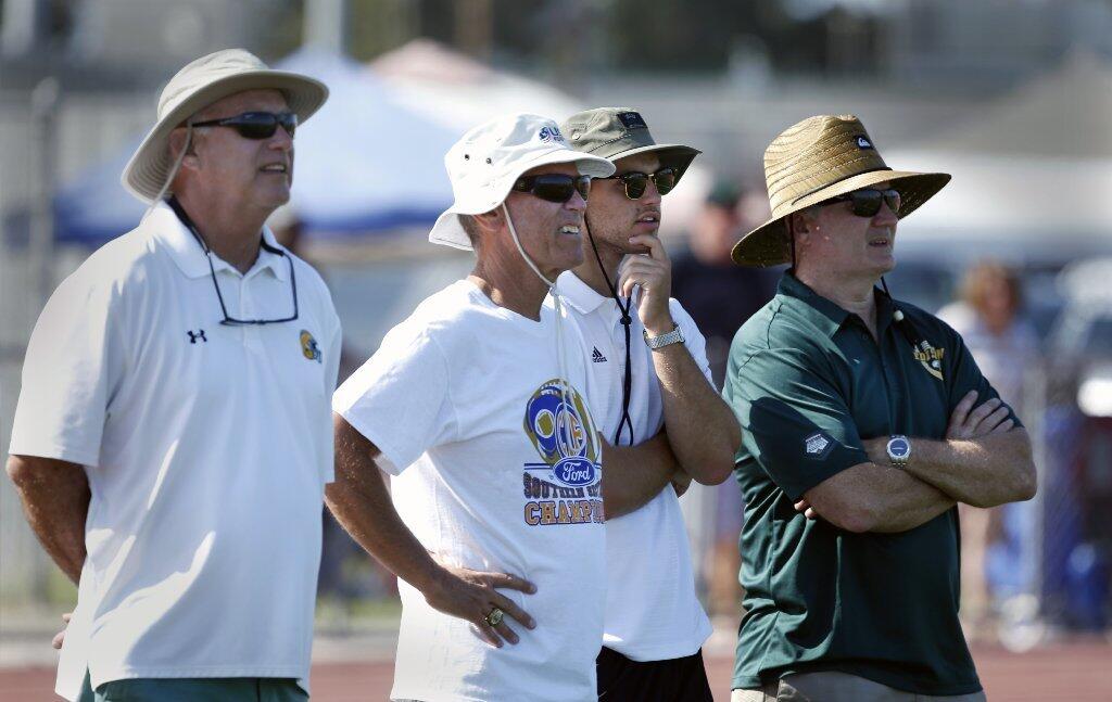From left, former Edison athletic director Bruce Belcher, former football coach Dave White, Garrett White and Tim O'Connor watch Edison compete in the Battle at the Beach seven-on-seven passing tournament.