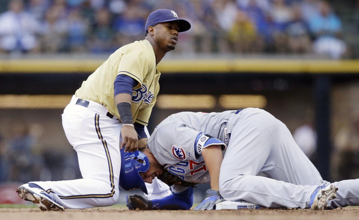 Cubs third baseman Kris Bryant slides safely into second base, but was hurt on the play and left the game after colliding with Brewers shortstop Jean Segura.