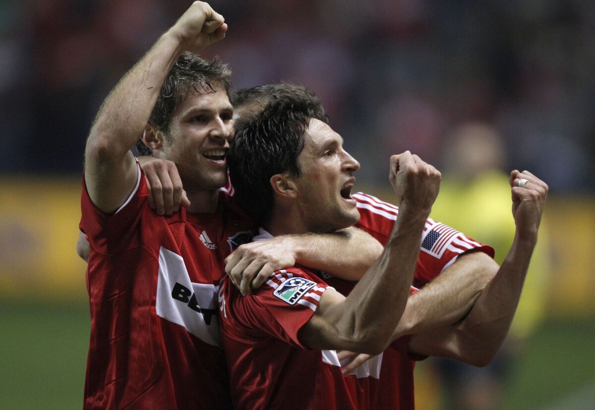 The Chicago Fire's John Thorrington is hugged by teammate Logan Pause after scoring a goal in 2009.