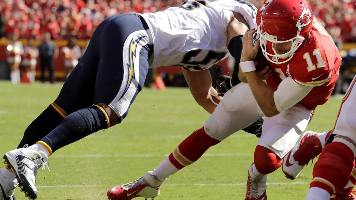 Chiefs quarterback Alex Smith dives past Chargers linebacker Tourek Williams to score the game-winning touchdown Sunday.