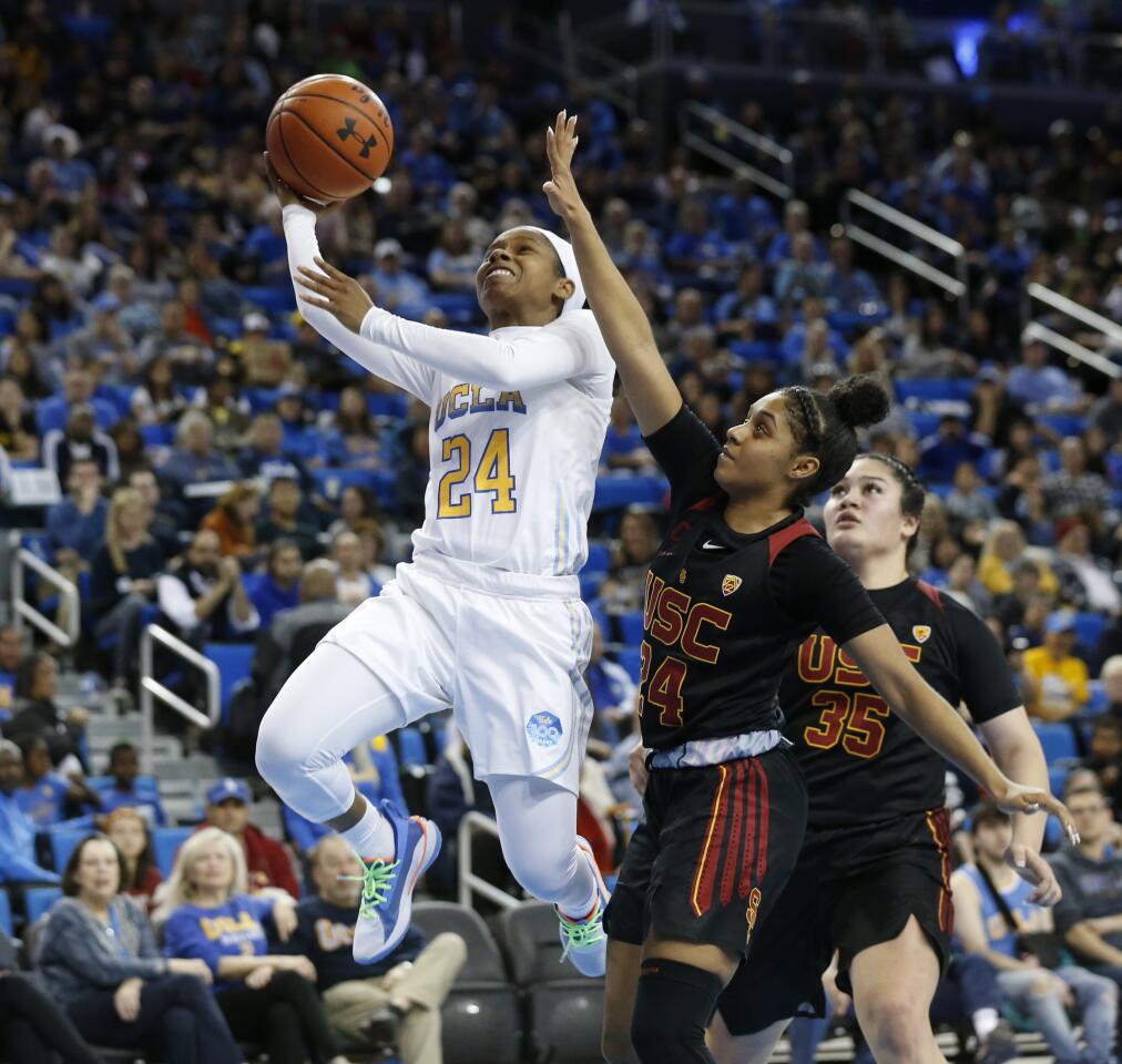 LOS ANGELES, CALIF. -- SUNDAY, DECEMBER 29, 2019: ]UCLA Bruins guard Japreece Dean (24) scores a basket guarded by USC Trojans guard Desiree Caldwell (24) in the second half at Pauley Pavilion in Los Angeles, Calif., on Dec. 29, 2019. UCLA won 83-59. (Gary Coronado / Los Angeles Times)