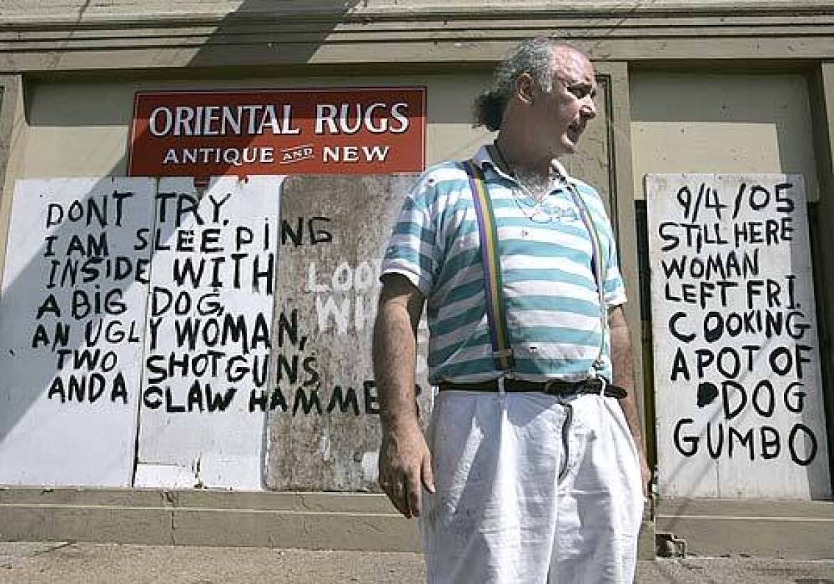 Bob Rue, owner of Oriental Rugs on St.Charles Ave in the Garden District of New Orleans, is hiding out in his shop, hoping authorities won't make him evacuate. The words on the front of his shop are meant to warn away looters.