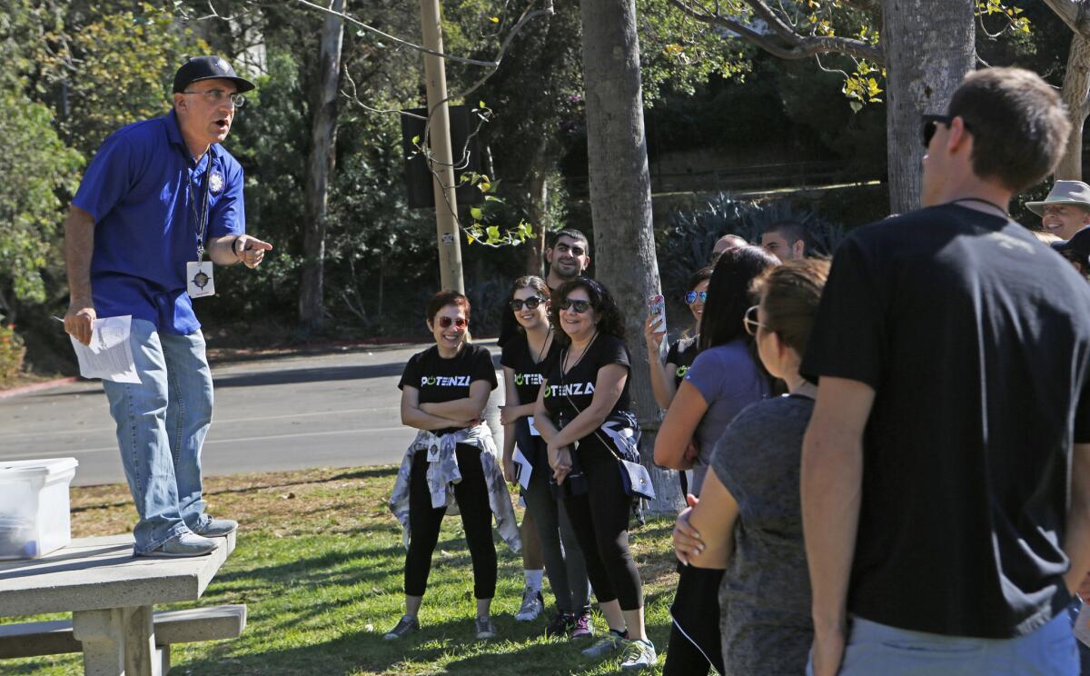 Bob Glouberman of Fantastic Race instructs five teams in a Hollywood Bowl parking lot.