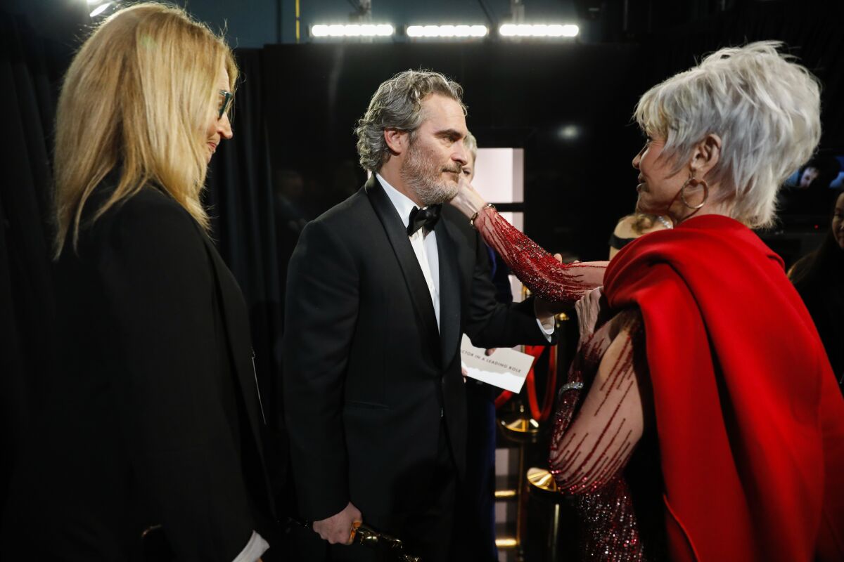 Joaquin Phoenix, winner of the lead actor Oscar for “Joker,” congratulated by Jane Fonda backstage at the Academy Awards in February. 