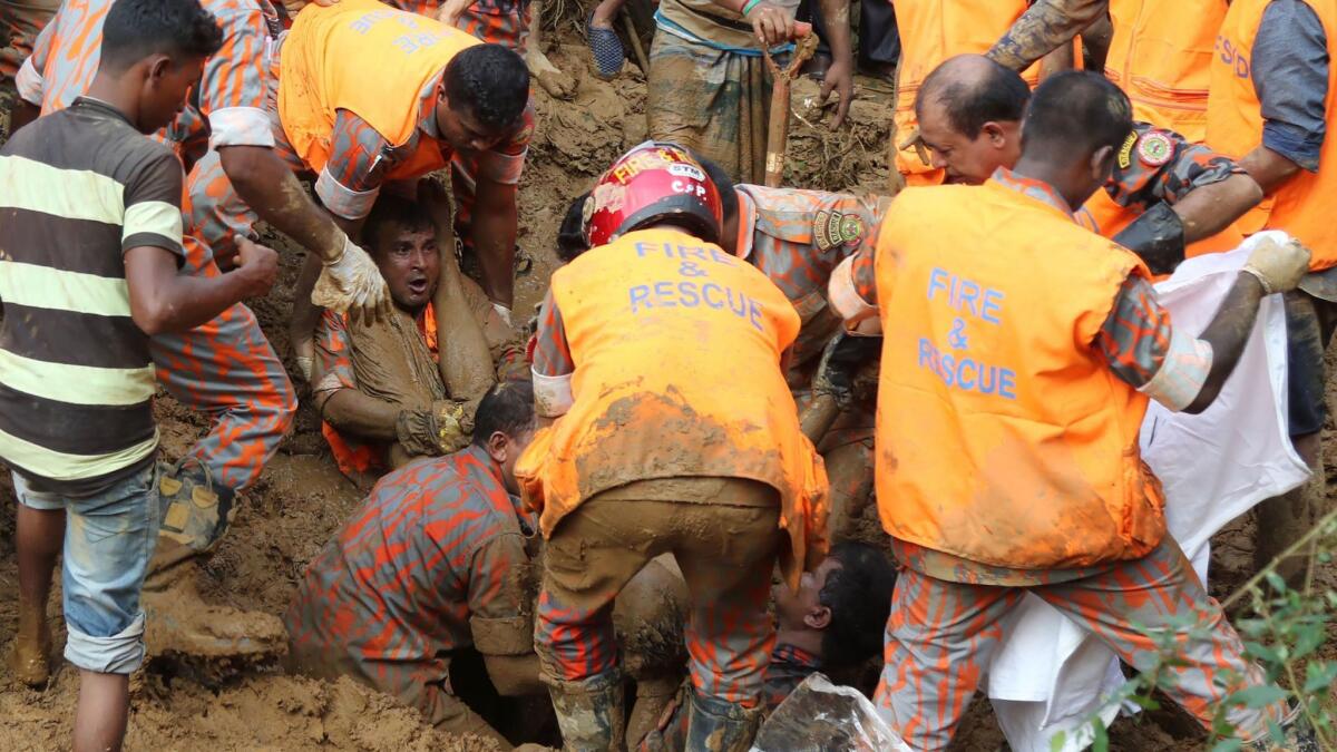 Bangladeshi firefighters search for bodies after a landslide in Rangamati on June 14, 2017.