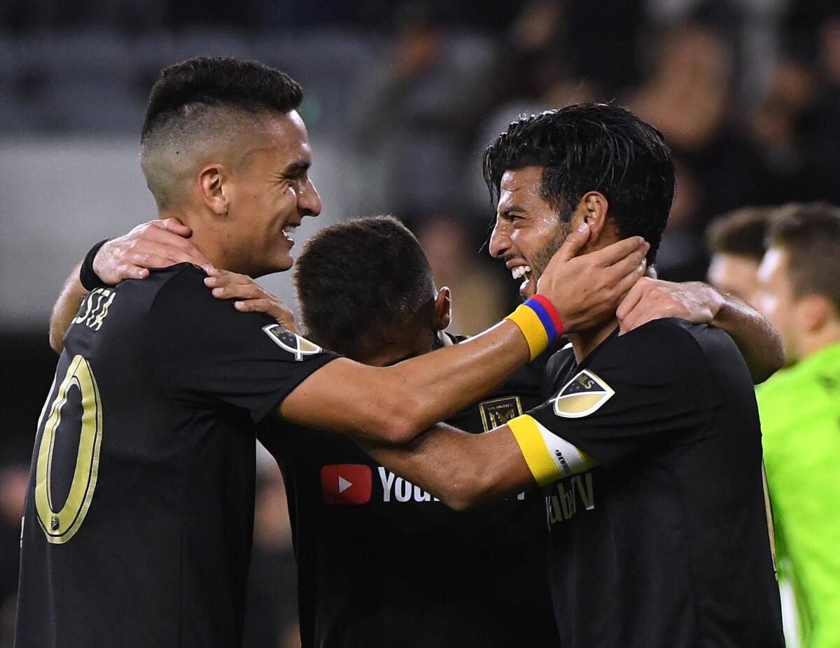 Carlos Vela celebrates with LAFC teammate Eduard Atuesta after scoring against FC Cincinnati in April.