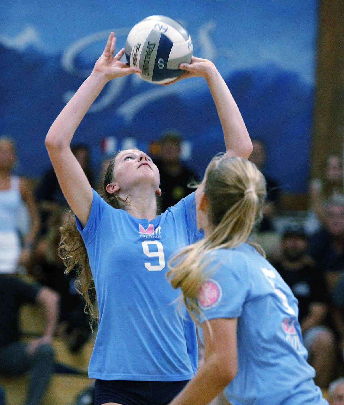 Corona del Mar's Bella Pouliot, shown setting the ball at Newport Harbor on Sept. 12, helped the Sea Kings finish as undefeated Surf League champions on Tuesday.