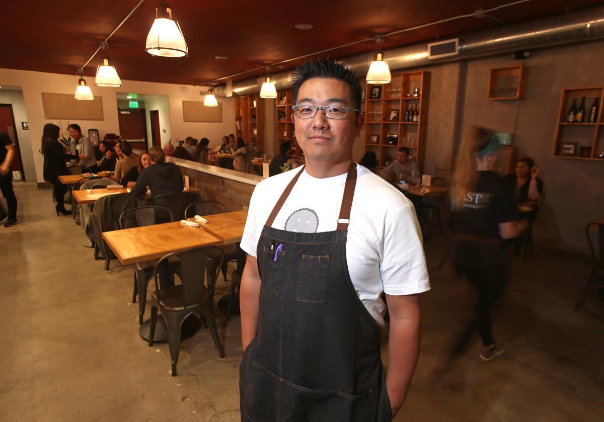 Chef John Park stands in the new Toast Kitchen+Bakery dining room in Costa Mesa.