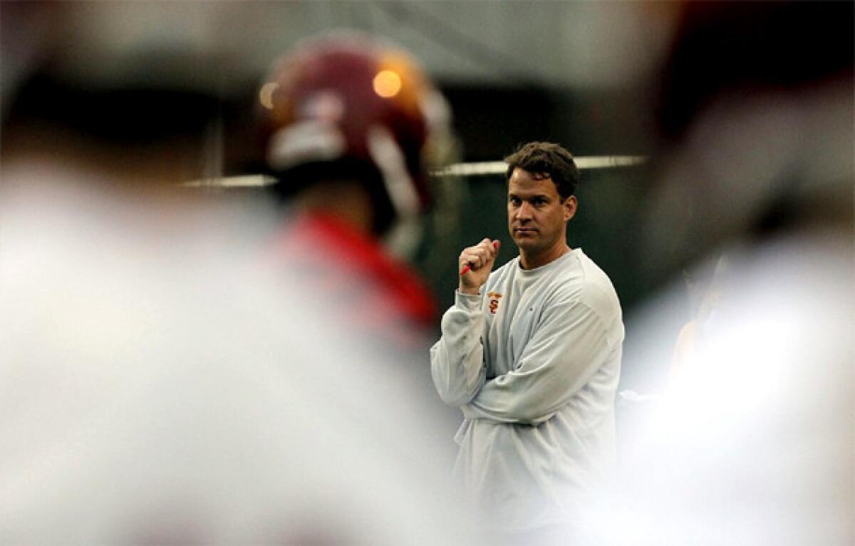 USC Coach Lane Kiffin watches the first day of spring practice.