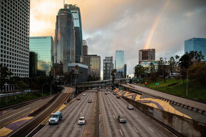 LOS ANGELES, CA --MARCH 23, 2020 - Traffic is lighter than usual, coming into downtown Los Angeles, CA, on the 110 freeway, March 23, 2020. The city is under a new mandate from California Gov. Gavin Newsom, to stay home, with only essential businesses allowed to stay open, as a preventative measure of the COVID-19 spread. (Jay L. Clendenin / Los Angeles Times)