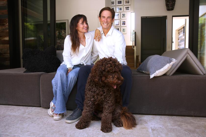 LOS ANGELES, CA - JULY 13, 2024 - Attorney Nathan Hochman and his wife Vivienne Vella spend time with their dog Lieu at their home in Los Angeles on July 13, 2024. Hochman is running to unseat Los Angeles Attorney General George Gascon. Hochman served as United States Assistant Attorney General for the Tax Division of the United States Department of Justice in 2008. Prior to that, he was an Assistant United States Attorney for the Central District of California from 1990 to 1997, serving in the Criminal Division. (Genaro Molina/Los Angeles Times)