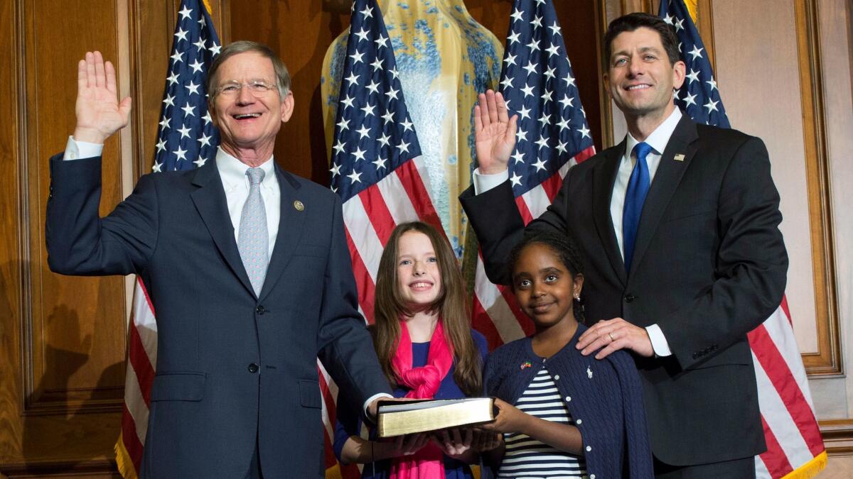 Rep. Lamar Smith (R-Texas), left, takes the oath of office from House Speaker Paul D. Ryan (R-Wis.) in January. The current term of the climate change denier will be his last.