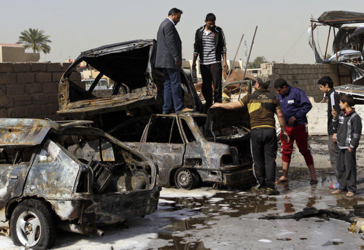 Destroyed cars litter the scene of a car bomb attack Sunday in the Ameen neighborhood of eastern Baghdad. A series of car bombs exploded within minutes of each other as Iraqis were out shopping in and around Baghdad, killing as many as 28 people.