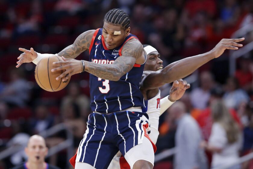 Houston Rockets guard Kevin Porter Jr. (3) pulls in a pass next to Detroit Pistons center Jalen Duren during the first half of an NBA basketball game Friday, March 31, 2023, in Houston. (AP Photo/Michael Wyke)