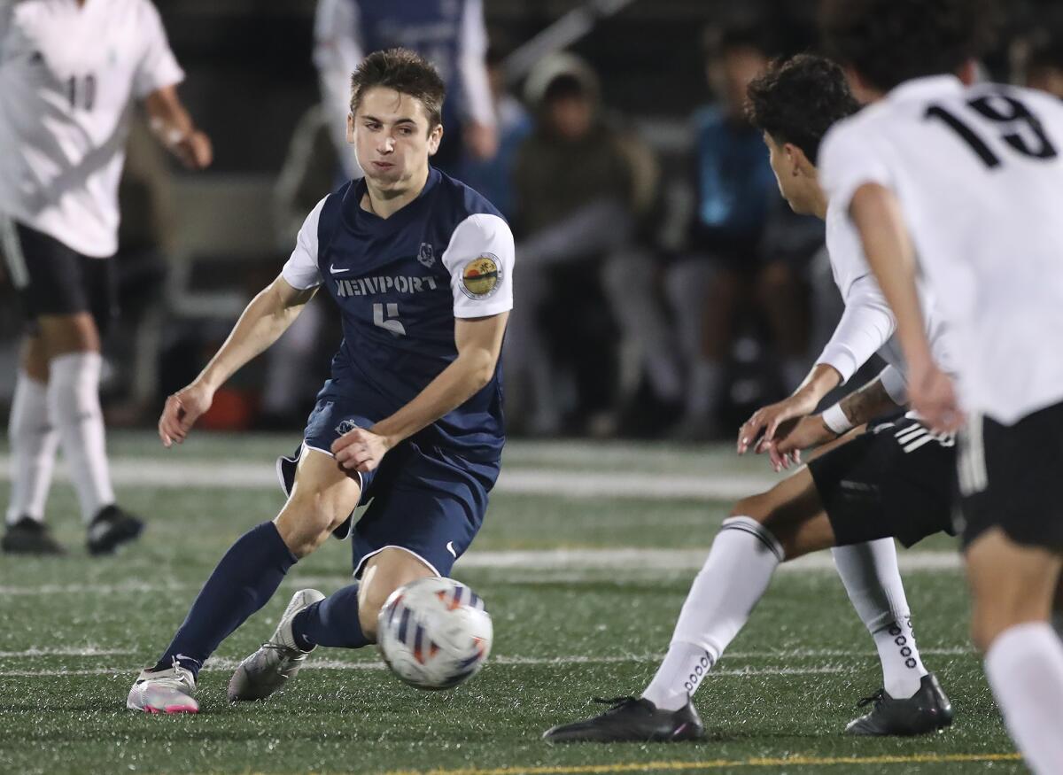 Newport Harbor's Jack Csergei (5) makes a move past defenders against Oxnard Pacifica on Tuesday.
