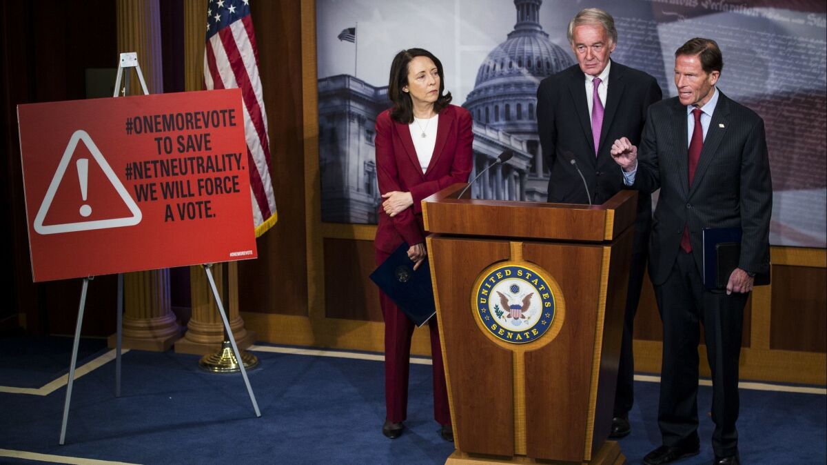 Sen. Richard Blumenthal (D-Conn.), right, speaks during a May 9 news conference on a Senate petition to force a vote to restore net neutrality regulations. With him are Sens. Maria Cantwell (D-Wash.) and Ed Markey (D-Mass.).