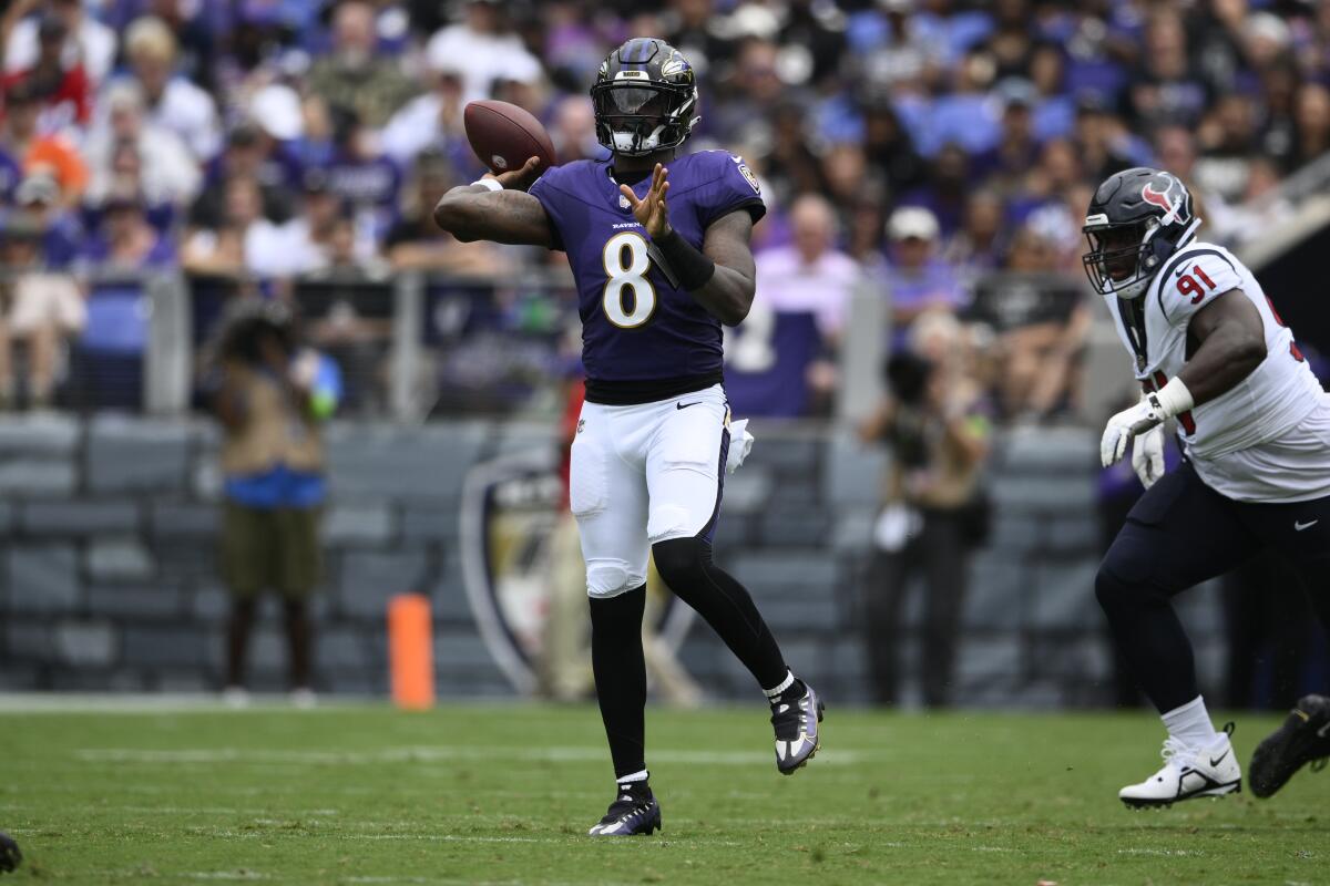 Ravens quarterback Lamar Jackson (8) scrambles against the Texans in the season opener.