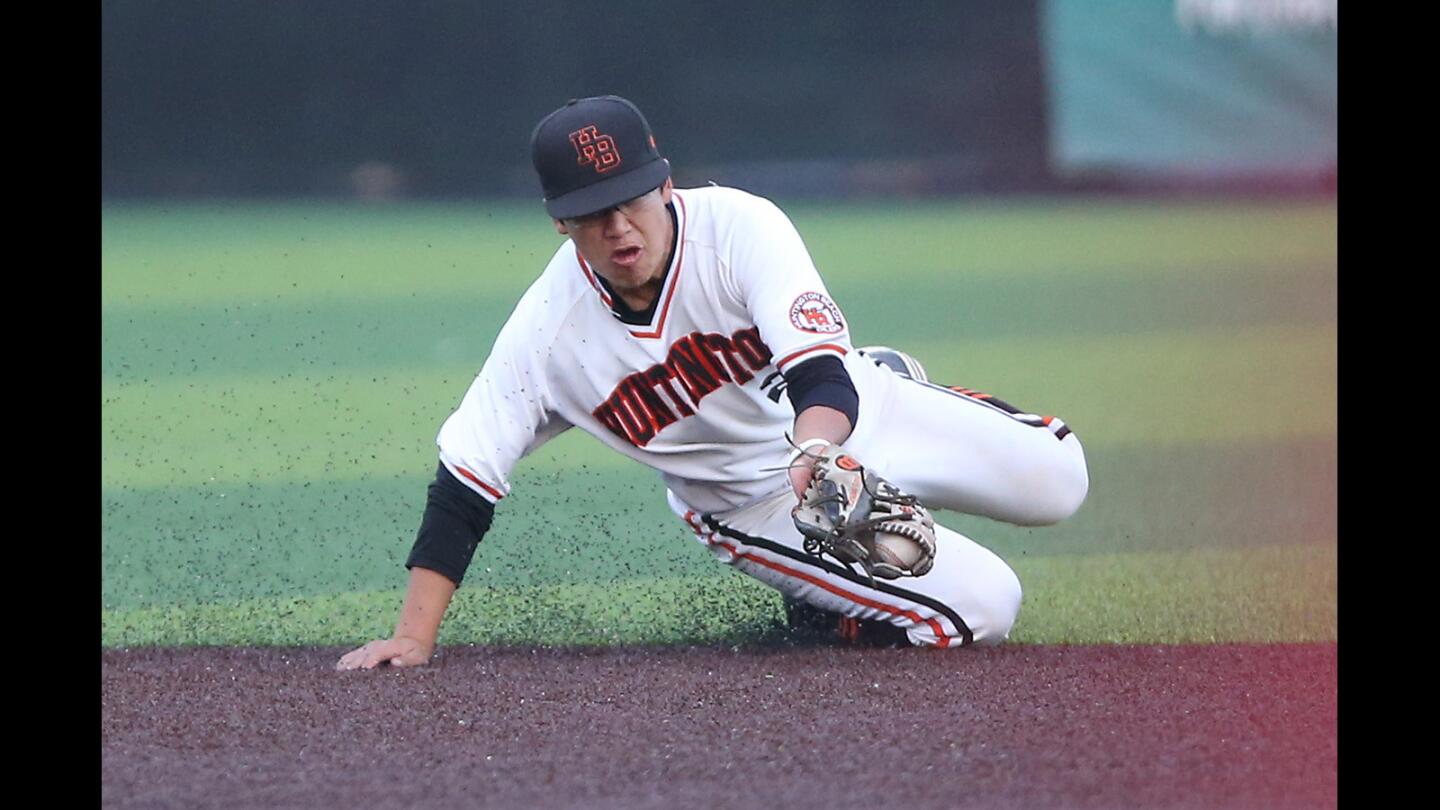 Huntington Beach High shortstop Cole Minato runs down an infield hit by San Diego Cathedral Catholic batter in the Boras Classic South tournament's ninth-place game at J Serra High on Friday.