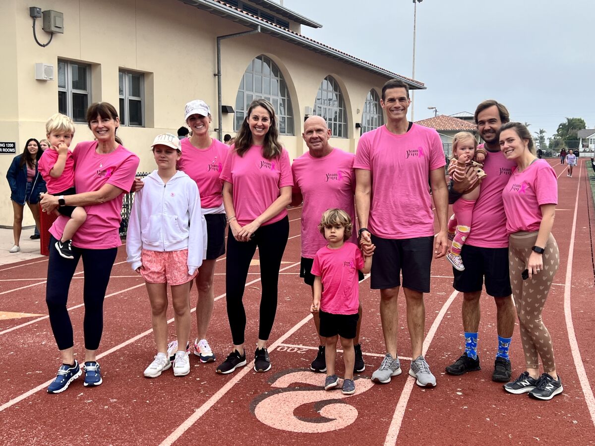 Jenn Marongiu and Tom Atwell (center), along with members of Marongiu's family, don "Team Jenn" shirts.