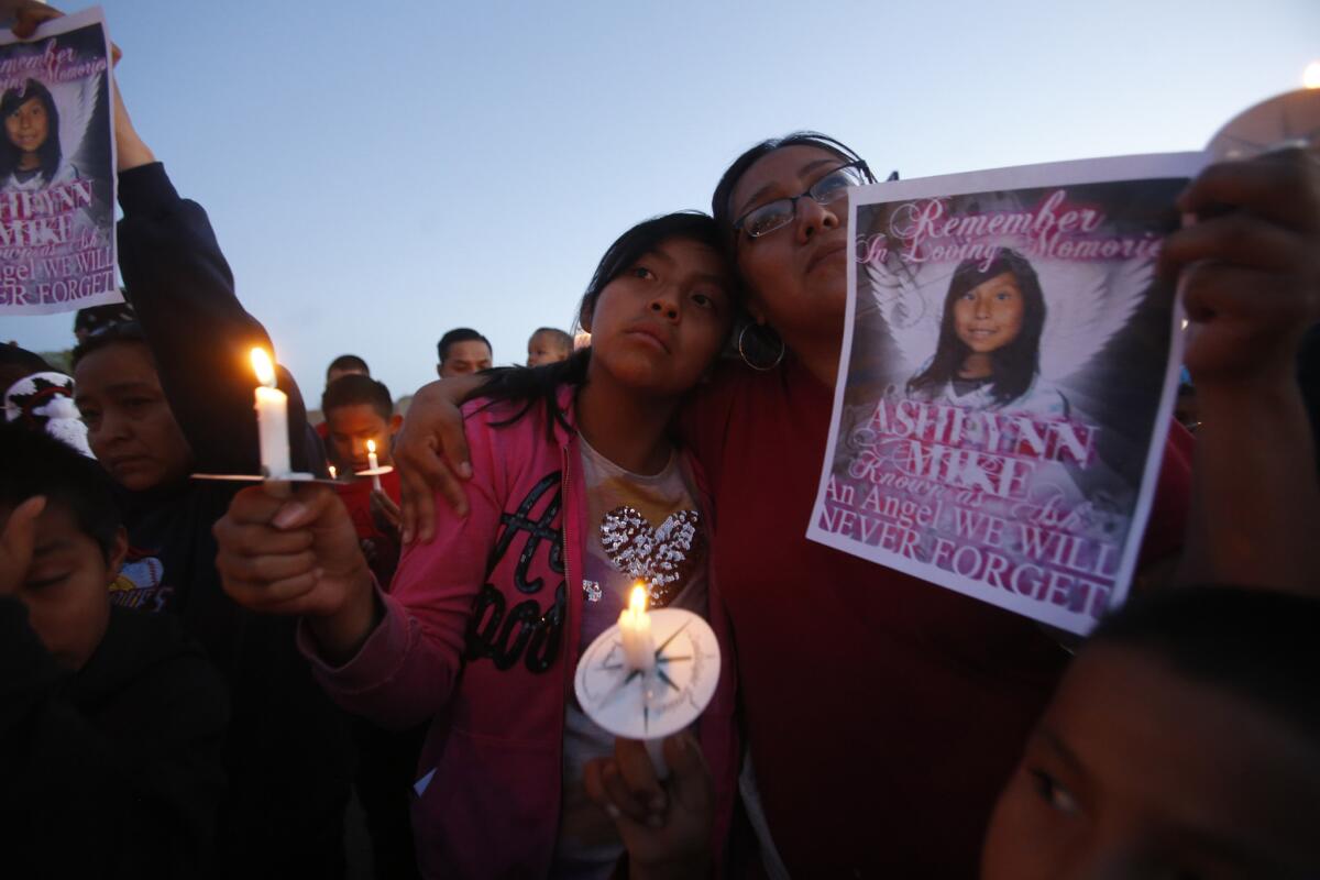 Klandre Willie, left, and her mother, Jaycelyn Blackie, participate in a candlelight vigil for Ashlynne Mike at the San Juan Chapter House in Fruitland, N.M.
