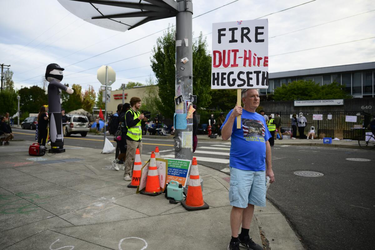 A person holds a sign.