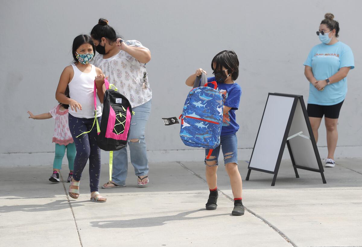 Briana and Brandon Melendez receive new backpacks at Rea Elementary.