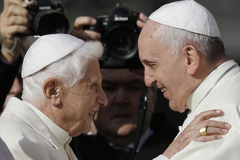 Pope Francis, right, hugs Pope Emeritus Benedict XVI