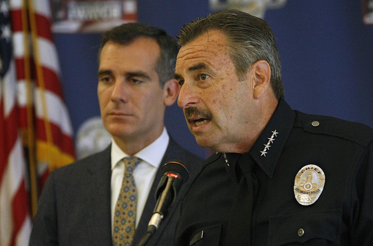 Los Angeles Chief Charlie Beck, right, announces mid-year crime statistics alongside Mayor Eric Garcetti in July.