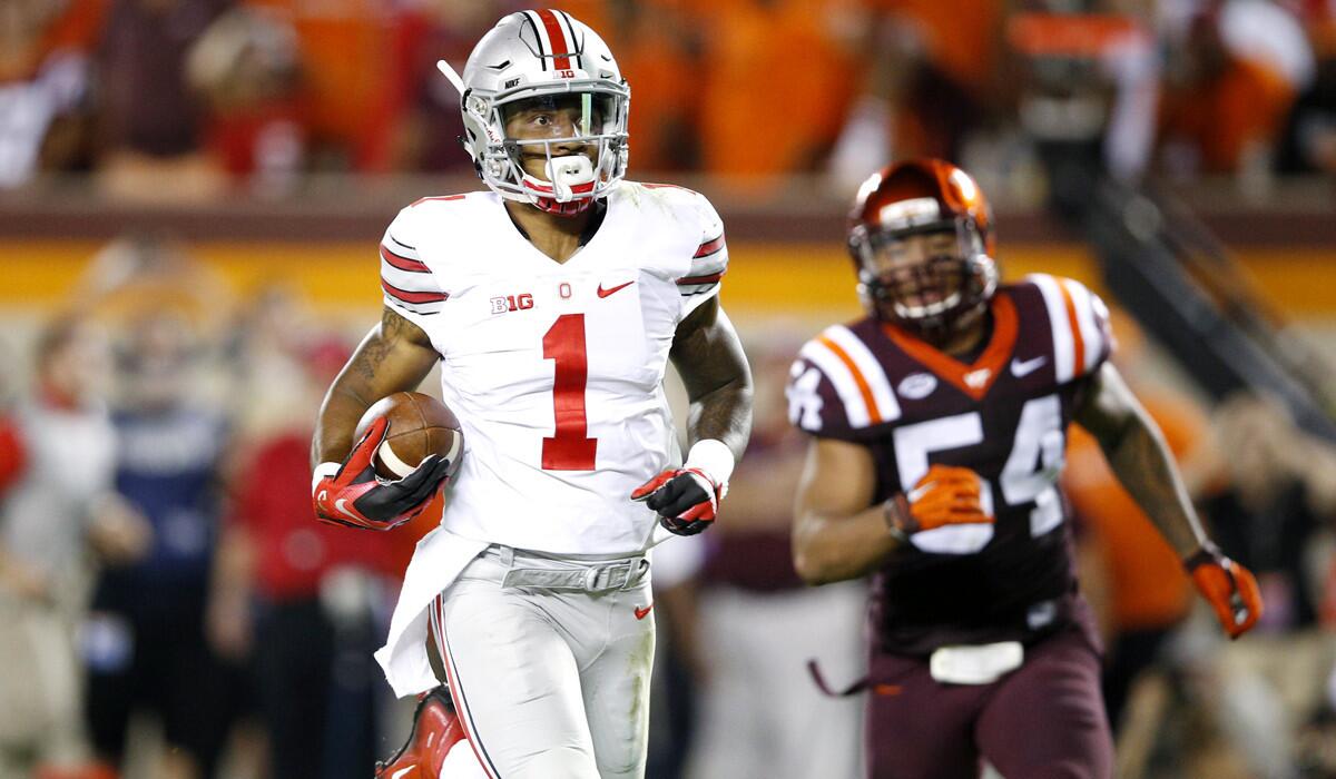 Ohio State Buckeyes' Braxton Miller runs for a 53-yard touchdown in the third quarter against the Virginia Tech Hokies on Monday