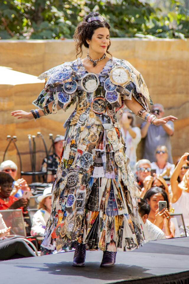 Elizabeth McGee models her own creation composed of magazines, tape, thread and staples intended to portray what H.G. Wells might have seen while he was writing "The Time Machine" in 1895. She won the award for Most Exciting Ensemble Inspired by "The Time Machine."