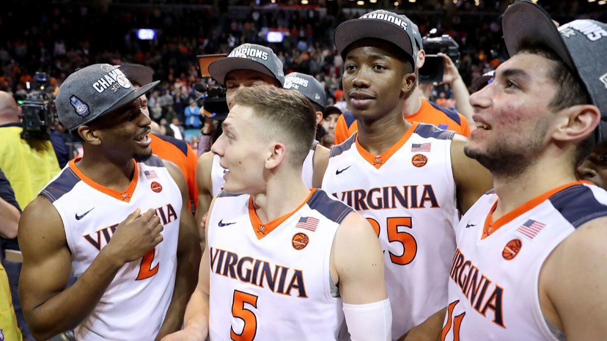 Virginia players celebrate after the Cavaliers' 71-63 win over North Carolina in the ACC tournament championship game on Saturday.
