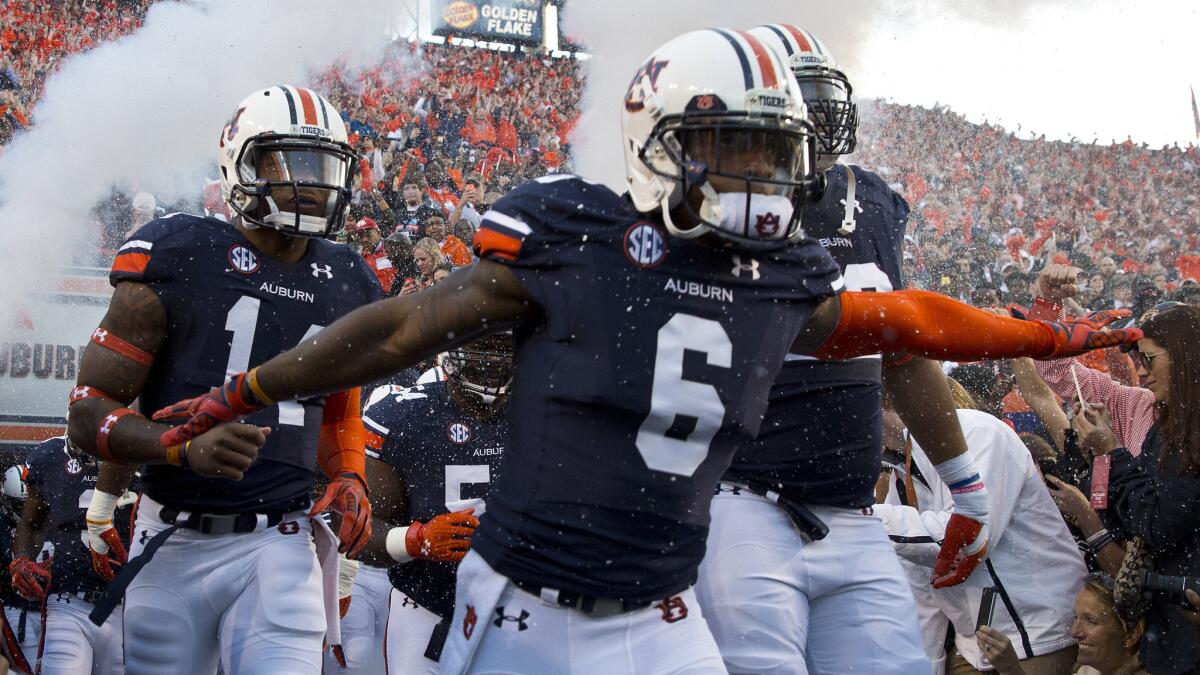 Auburn players run onto the field before the Tigers' win over Louisiana State on Saturday.