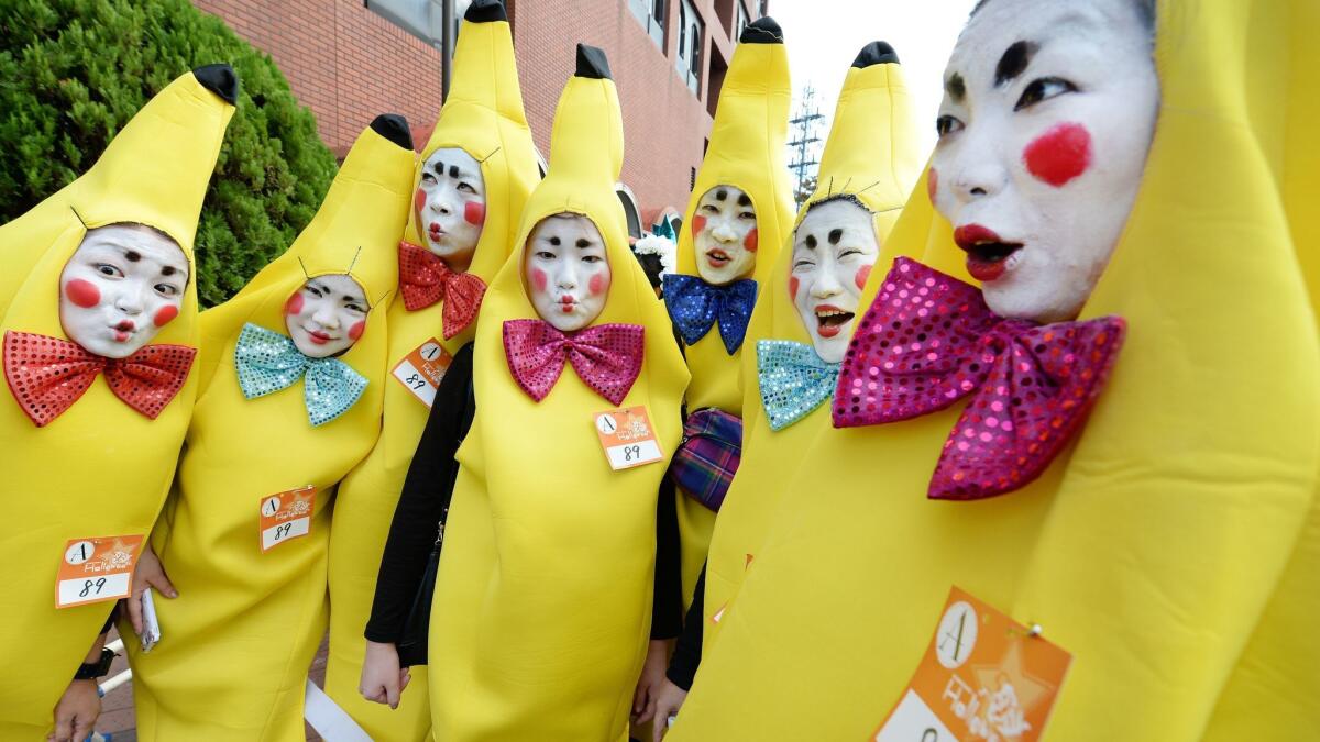 Participants wear costumes as they pose for pictures before the Halloween Parade in Kawasaki, a suburb of Tokyo,