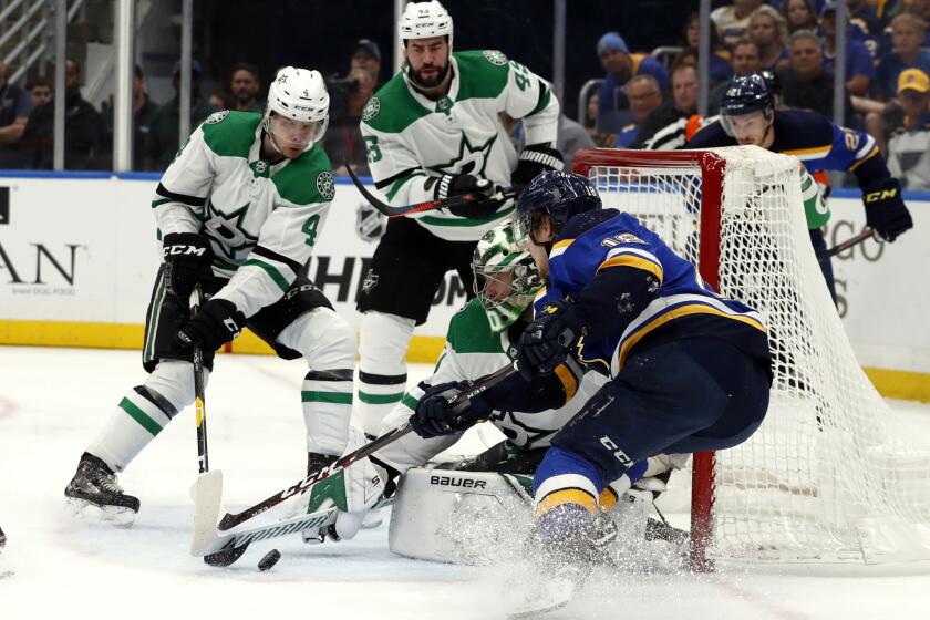 St. Louis Blues' Robert Thomas, right, is unable to score past Dallas Stars goaltender Ben Bishop, Miro Heiskanen (4) and Valeri Nichushkin (43) during the second period in Game 2 of an NHL second-round hockey playoff series Saturday, April 27, 2019, in St. Louis. (AP Photo/Jeff Roberson)