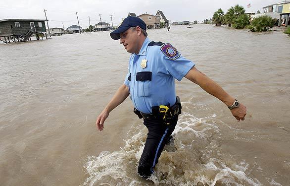 Randy Smith, chief of police in Surfside Beach, Texas, wades through floodwaters brought in by Hurricane Ike. He is encouraging residents to evacuate before the full force of the storm hits and conditions get worse.
