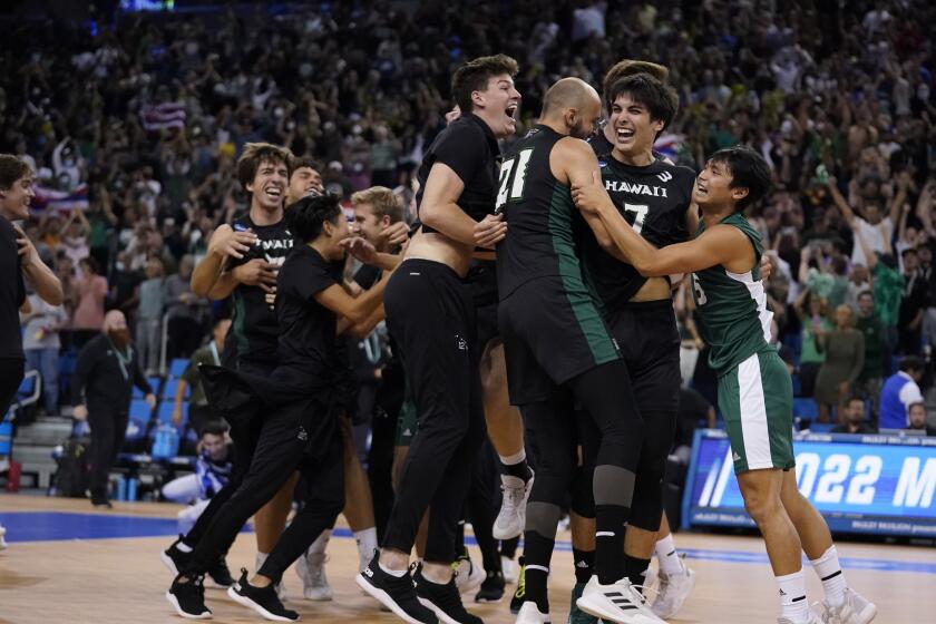 Hawaii players celebrate after defeating Long Beach State to win the NCAA men's college volleyball championship May 7, 2022.