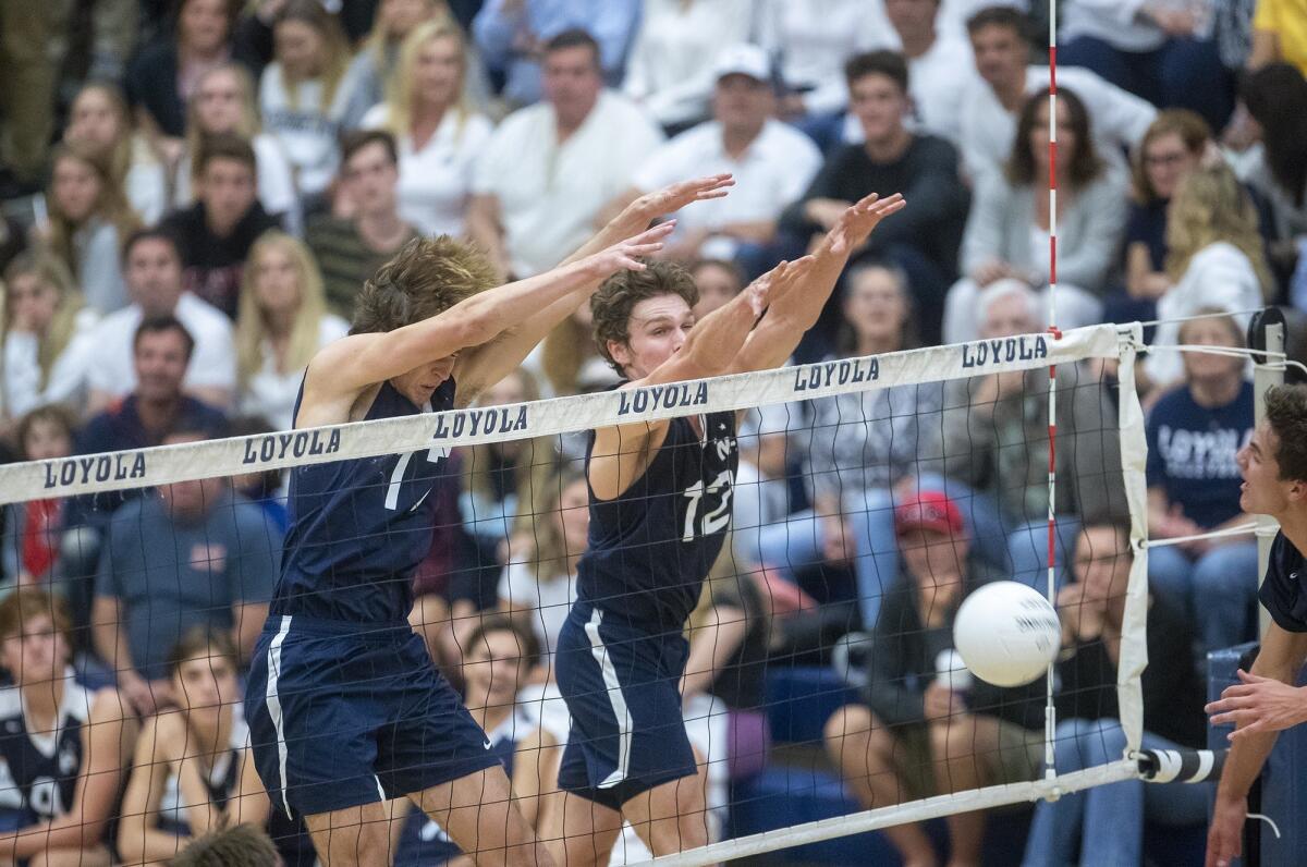 Newport Harbor High's Alec Patterson, left, and and Dayne Chalmers block a shot during a CIF Southern Section Division 1 semifinal playoff match at Los Angeles Loyola on Wednesday.