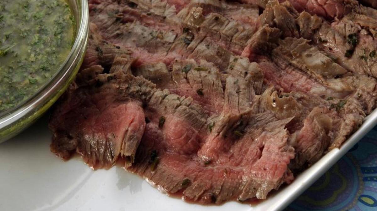 Grilled flank steaks with chimichurri sauce is a quick, easy meal.