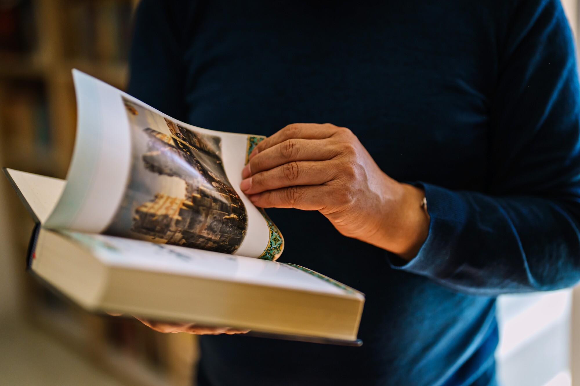 A person holds an open book 