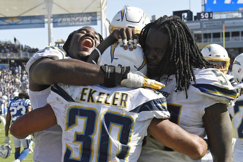 CARSON, CA - SEPTEMBER 08: Running back Austin Ekeler #30 of the Los Angeles Chargers is congratulated by Justin Jones #93 and Melvin Ingram #54 after scoring the winning touchdown in overtime against Indianapolis Colts at Dignity Health Sports Park on September 8, 2019 in Carson, California. (Photo by Kevork Djansezian/Getty Images)