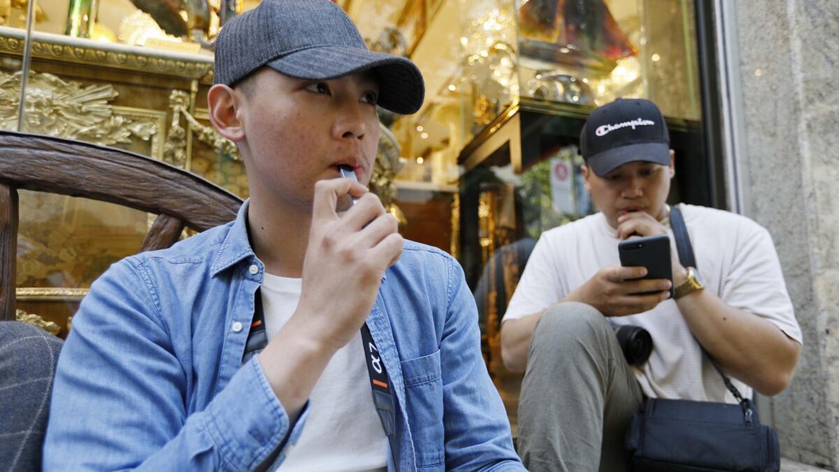 Men smoke electronic cigarettes in San Francisco.