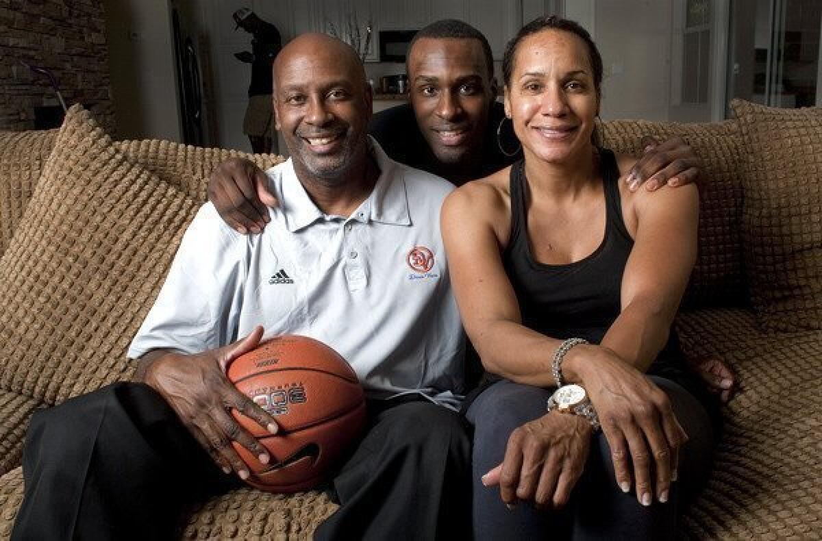 Former UCLA basketball star Shabazz Muhammad, center, poses for a photo with his parents, Ron and Faye, in Las Vegas.