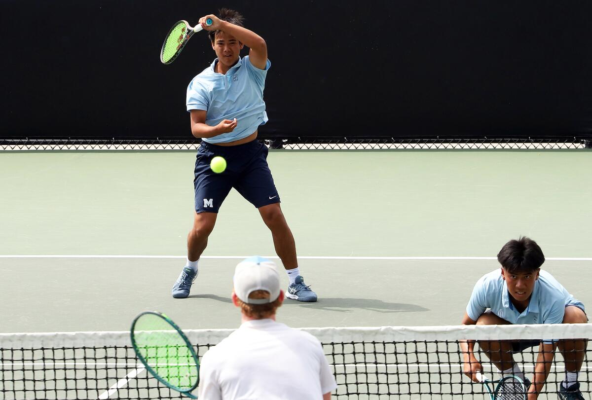 Marina's Trevor Nguyen returns a serve against JSerra on Thursday at the Biszantz Family Tennis Center.