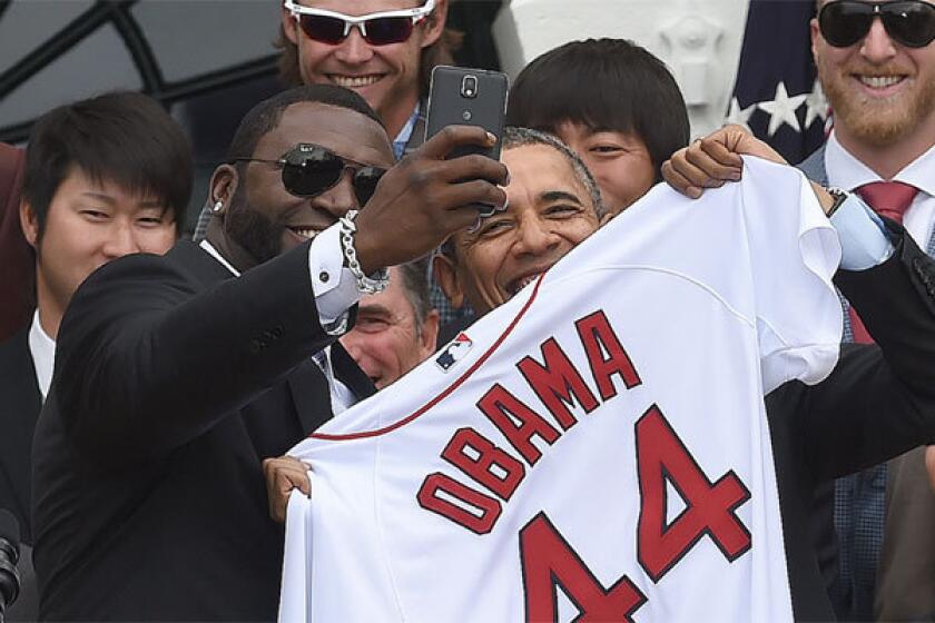 Boston designated hitter David Ortiz takes a selfie with President Obama during a ceremony at the White House.