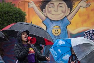 Los Angeles, CA - March 21: LAUSD employees and students strike in the rain in front of Farmdale Elementary School in El Sereno Tuesday, March 21, 2023. The massive three-day strike begins, with LAUSD teachers, bus drivers, custodians and other workers shutting down Los Angeles public schools. (Allen J. Schaben / Los Angeles Times)