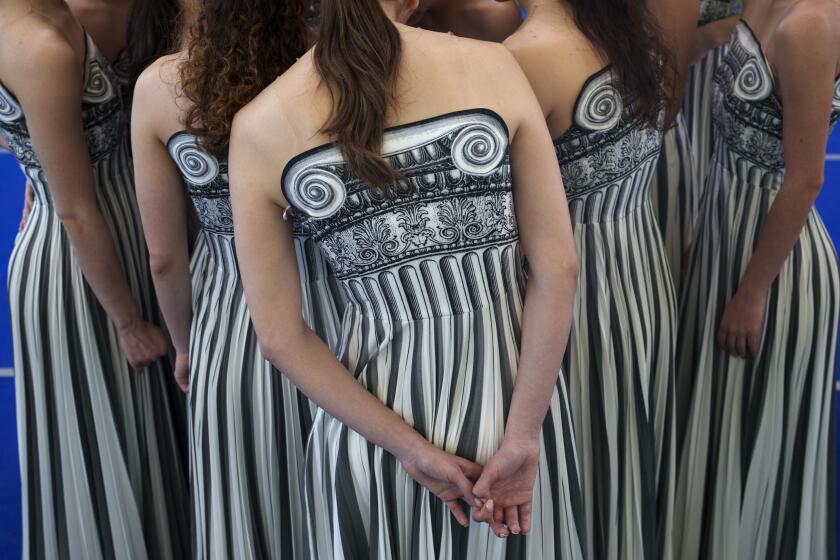 Performers dressed as priestesses attend a practice for the Paris Olympic flame-lighting ceremony, in Athens, Greece, March 30, 2024. The flame for this summer's Paris Olympics is lit at the birthplace of the ancient Olympic Games in southern Greece in a meticulously choreographed ceremony. (AP Photo/Petros Giannakouris)