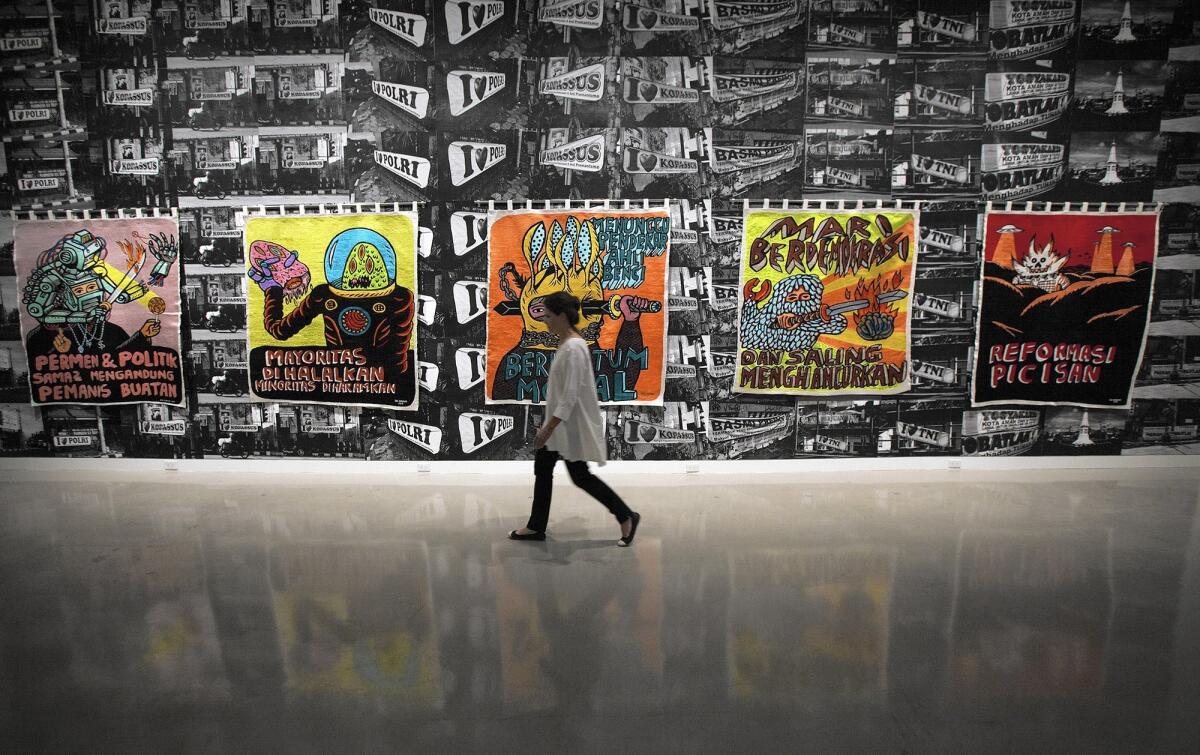 A visitor tours the 2013 California-Pacific Triennial exhibit at the Orange County Museum of Art in Newport Beach.