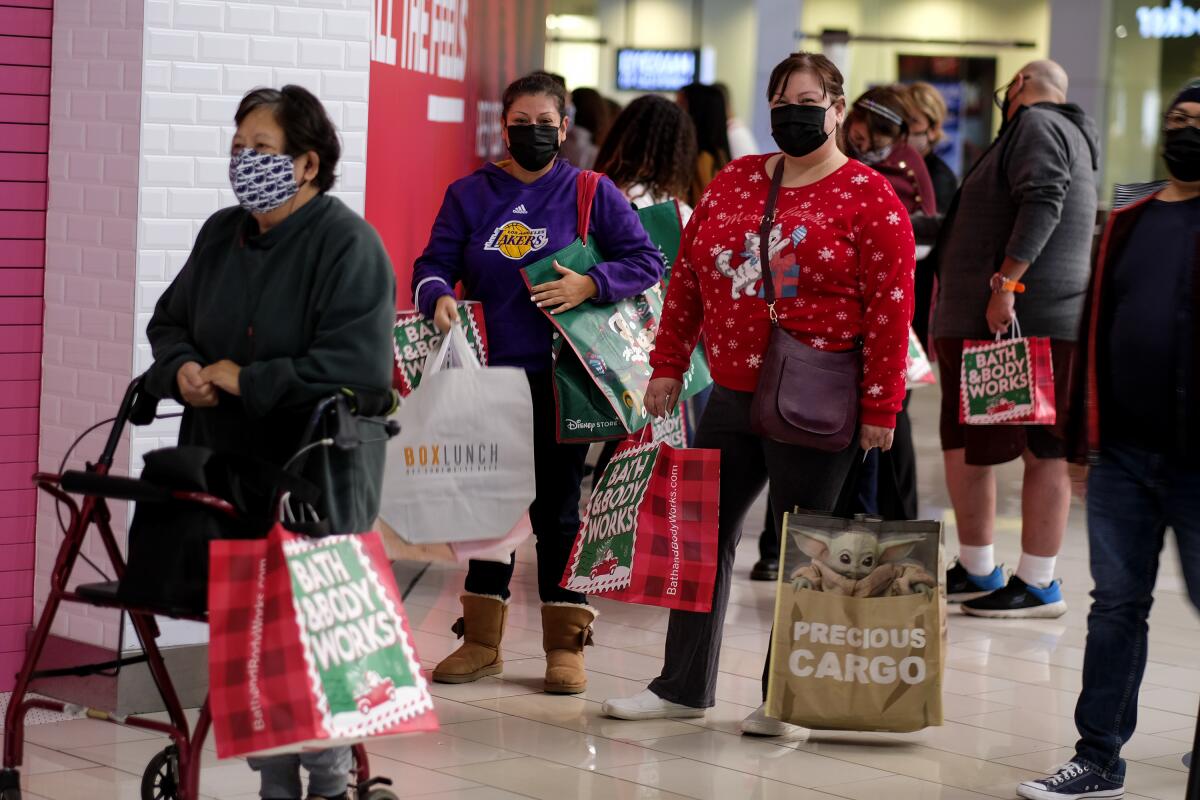 Shoppers wait in line to enter a store at the Glendale Galleria on the Friday after Thanksgiving.